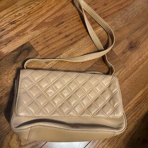 Aigner purse has a quilted like pattern w/ a magnetic closure &  internal zipper